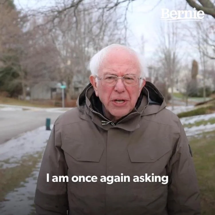 Bernie Sanders meme template: the senator standing outside in a heavy winter coat speaking to the camera
