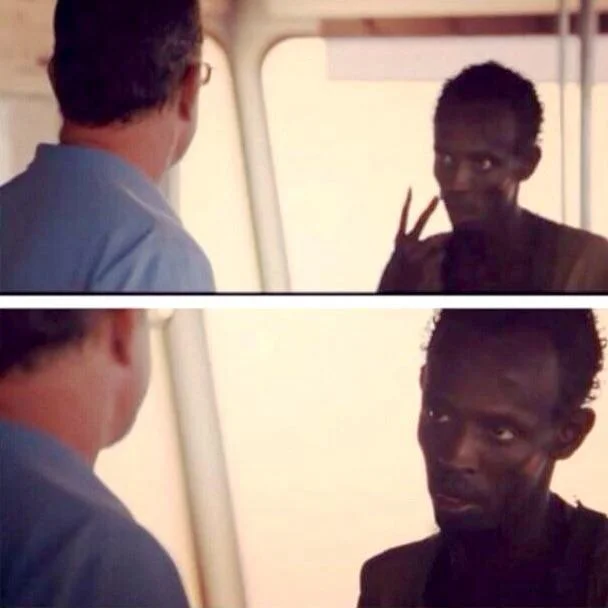 Two-panel Captain Phillips scene where the pirate takes command