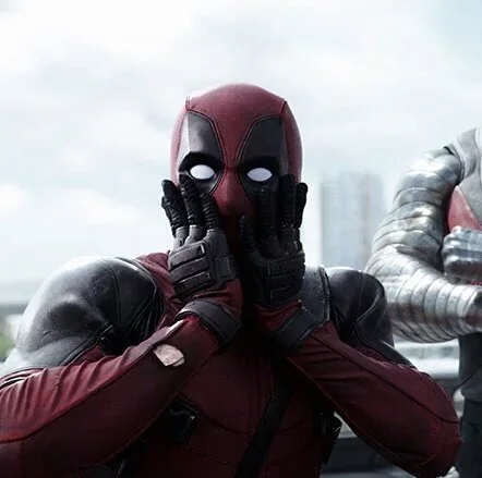 Deadpool with hands on cheeks looking exaggeratedly shocked