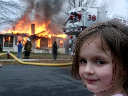 Disaster Girl meme template: a young girl smirking at the camera in front of a burning house