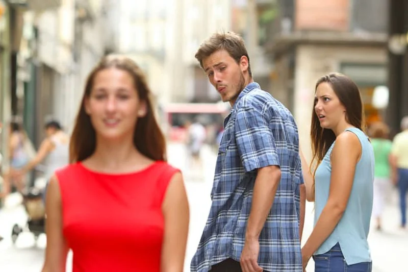 Distracted Boyfriend meme template: a man turns to look at another woman while his girlfriend looks on in disapproval
