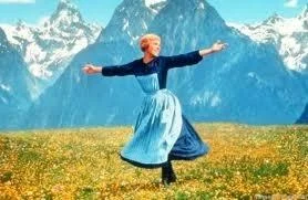 Maria from The Sound of Music spinning joyfully in a mountain meadow