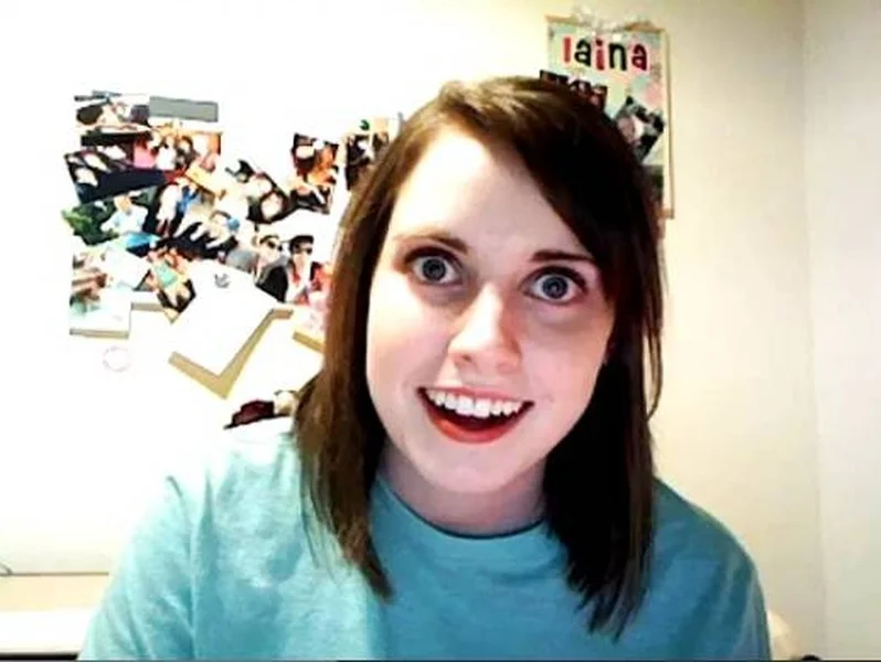 Overly Attached Girlfriend meme template: a young woman staring unblinkingly at the camera with wide eyes
